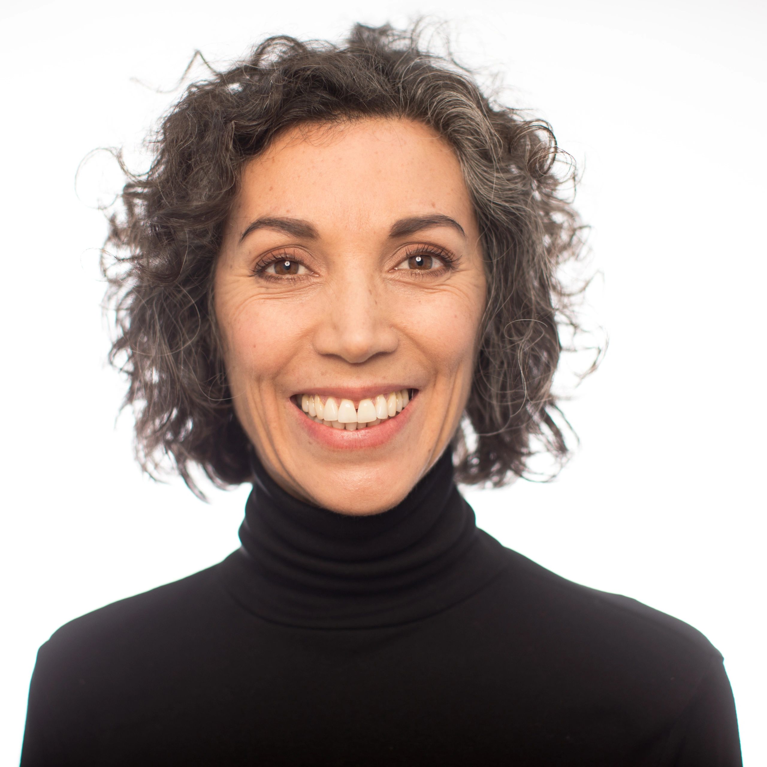 Mature woman smiling against a white background