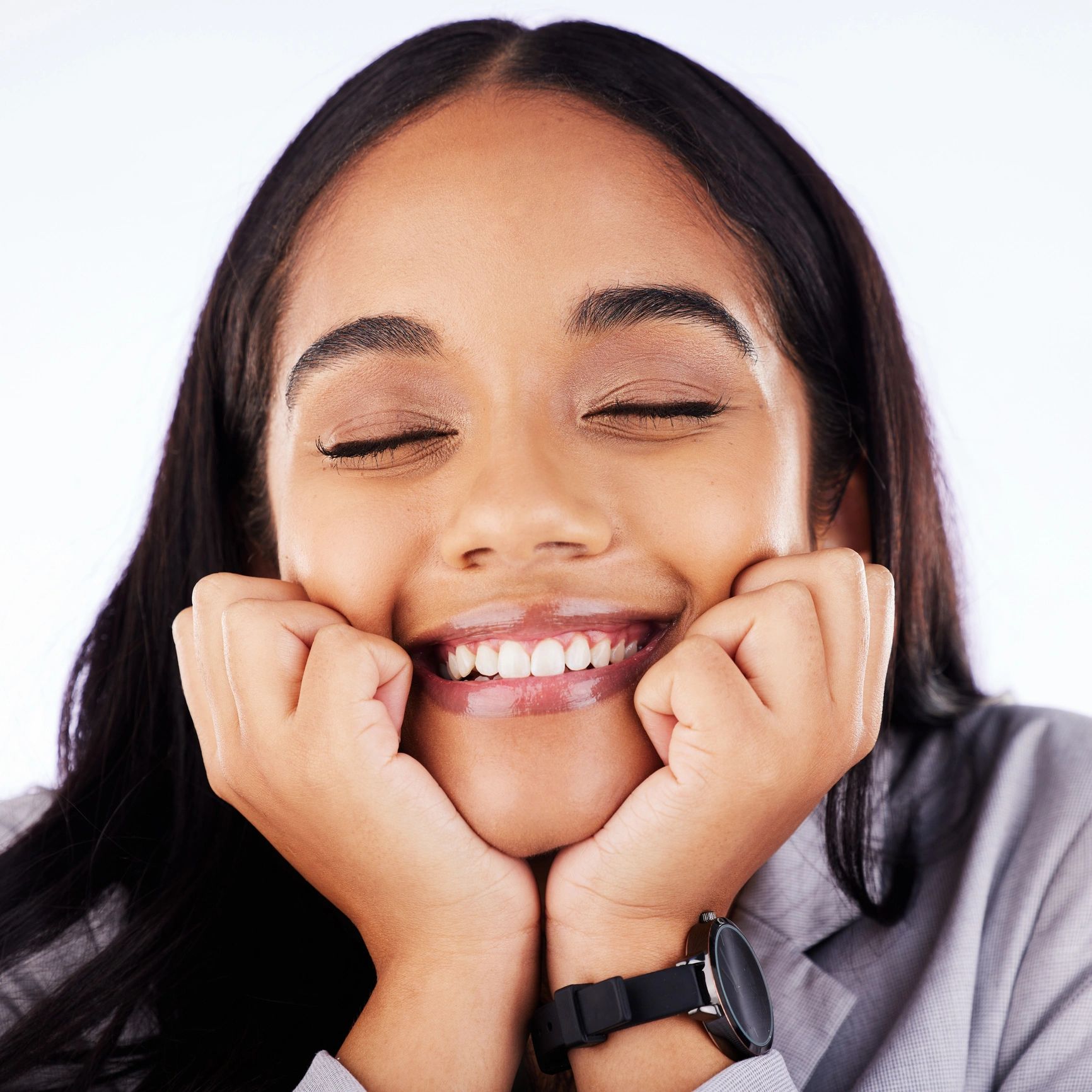 Joyful woman smiling with hands on her face