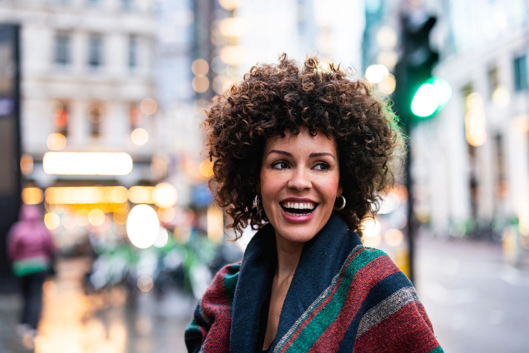Happy woman smiling on a city street